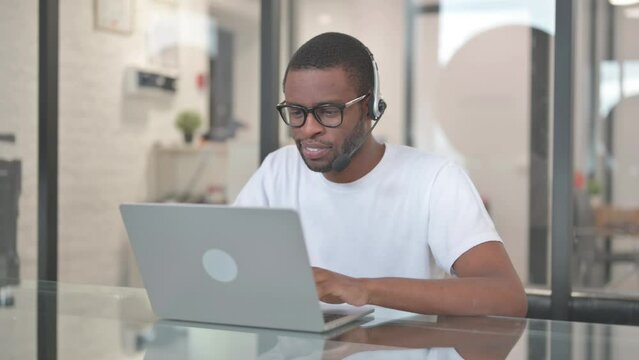 African American Man with Headset Working in Call Center
