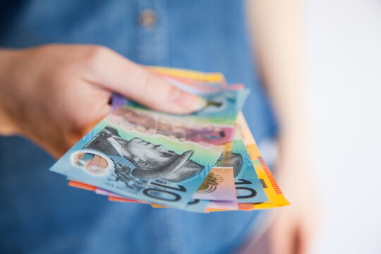 Woman holding a selection Australian currency notes