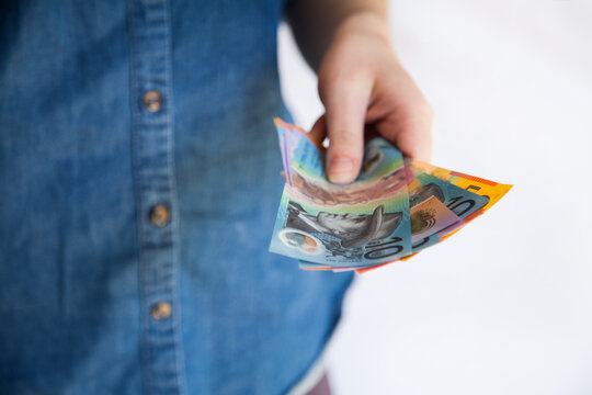 Woman holding Australian money notes in hand