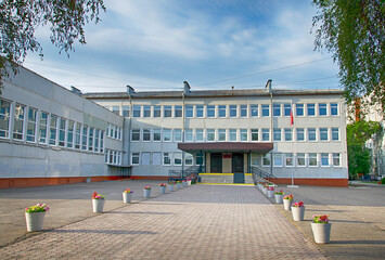 The central entrance to the school is decorated with flowers, spring, Russia