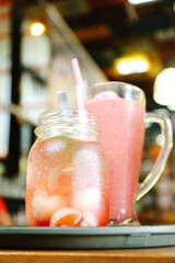 refreshing cold drink, a jar of lychee mojito and a glass of strawberry juice