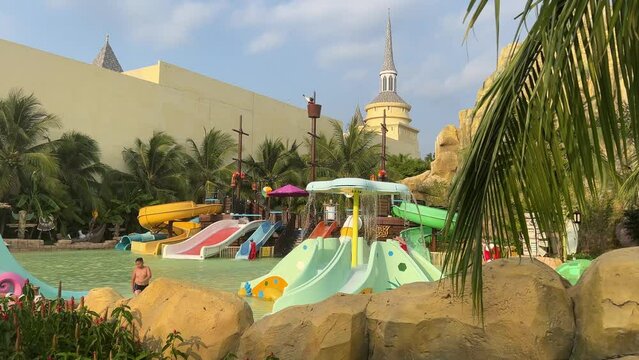 Aqua Park Palm trees roller coaster rides games Water park slides palm trees slides attractions recreation for children and adults great time Vinpearl, VinWonders Nam Hoi An, Quang Nam