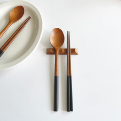 wooden spoon and chopstick set on the white table.