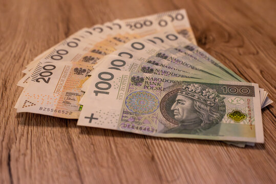 two bundles of money - 200 and 100 PLN