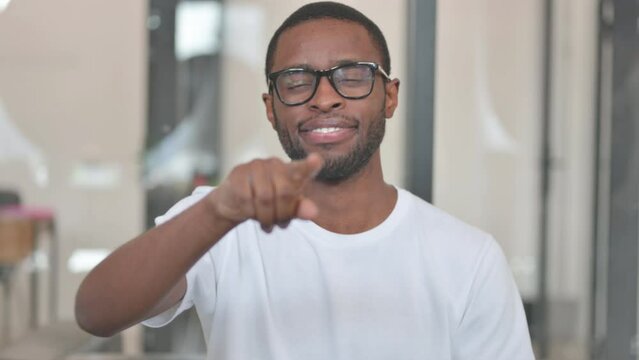 Portrait of Casual African Man Pointing at Camera