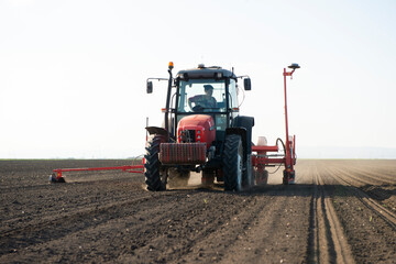 Sowing crops at agricultural fields in spring