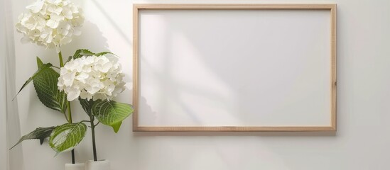 Wooden frame with hydrangea flower and white mat on white background. Mock-up.