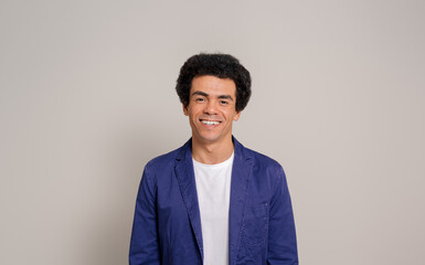 Portrait of happy young male professional with afro hairstyle posing confidently on white background