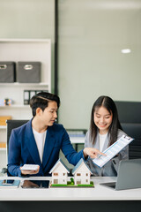 Real estate broker agent presenting and consult to customer to decision making sign insurance form agreement, home model,