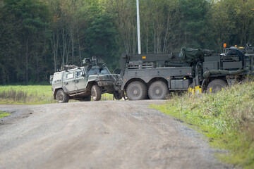 British army MAN SVR (Support Vehicle Recovery) 8x8 Truck towing a stricken Panther command and...
