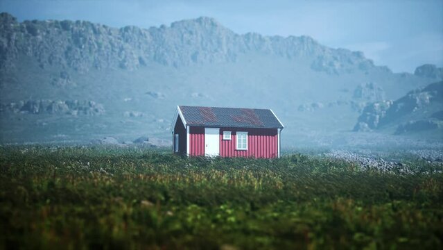 Red house on a rocky island