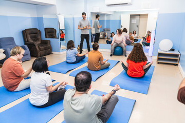 A diverse group engages in a yoga class, including two with Down syndrome.