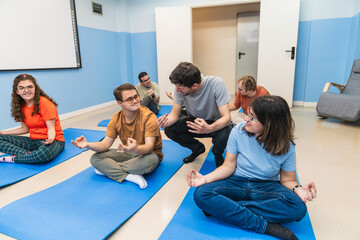 A compassionate yoga instructor interacts with a student with Down Syndrome