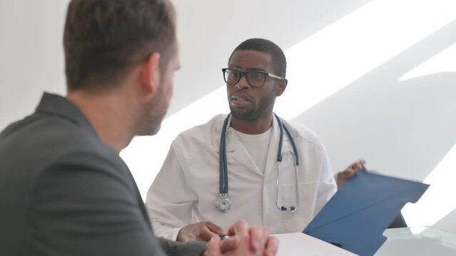 Close up of Doctor Talking with Patient in Clinic