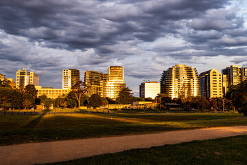 The modern apartments and skyscrapers near Albert Park Lake in Melbourne under the storm cloud in...