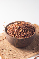 Buckwheat groats on wooden background. Healthy cereal concept.  