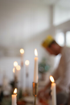 blurry candles with man out of focus in the background