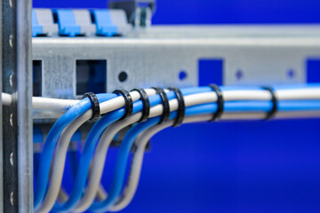 Connection of modules in an electrical distribution cabinet using electrically insulated wires.Soft focus.