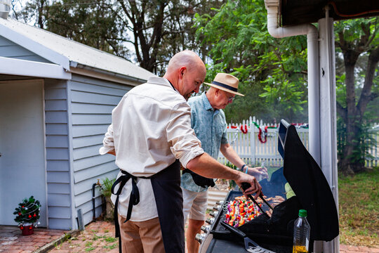 Aussie men cooking a barbeque lunch for family at Christmas time