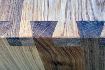 Wooden dinner table surface. Natural wood furniture close view