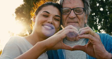 Father and daughter making a heart shape with their hands	 - 759671321