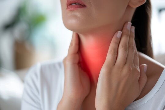 Flame at the neck of a woman. Concept of sore throat, pharyngitis, laryngitis, thyroiditis, choking.