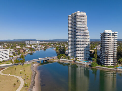 Aerial view of high rise apartment towers along a waterfront esplanade and river