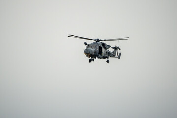 British army AgustaWestland AW159 Wildcat AH1 helicopter in low level flight, Wilts UK