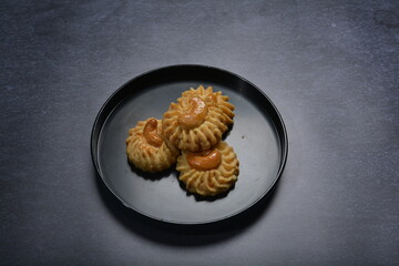 handmade baked luxury almond cashew nut butter quqi cookies and gold leaf plate fork knife on dark background pastry cafe dessert halal vegan party restaurant food gluten free menu