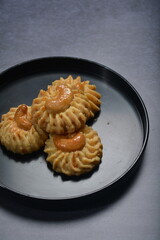 handmade baked luxury almond cashew nut butter quqi cookies and gold leaf plate fork knife on dark background pastry cafe dessert halal vegan party restaurant food gluten free menu