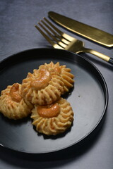 handmade baked luxury almond cashew nut butter quqi cookies and gold leaf plate fork knife on dark background pastry cafe dessert halal vegan party restaurant food gluten free menu