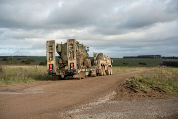 British army Foxhound 4x4-wheel drive protected patrol vehicle on a low loader trailer behind a...