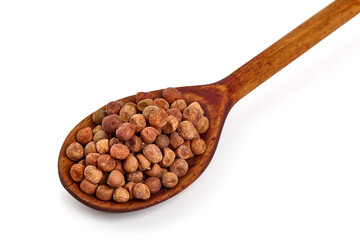 Gray peas on a wooden spoon, isolated on white background.