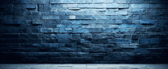 Background and texture of dark blue stone bricks with light from above. Panorama.