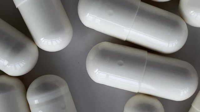 a lot of pills. top view a lot of pills. Slow motion video. High quality video in 4K format.