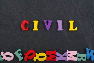 CIVIL word on black board background composed from colorful abc alphabet block wooden letters, copy space for ad text. Learning english concept.