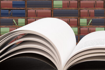 Books on the table in the library, against the background of wooden cabinets with books. Back to...