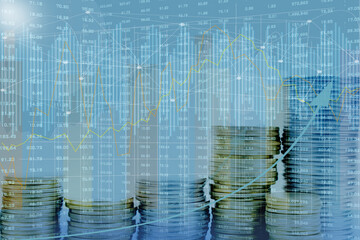 Double exposure of the city, stock market, graphics, rows of coins. © lana_u