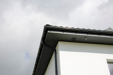 Plastic gutter system on a house with security camera