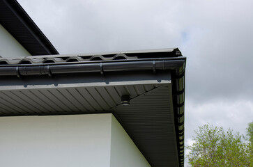 Gray plastic rain gutter system on a house