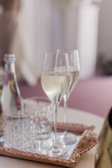Elegant champagne flutes arranged on mirrored tray