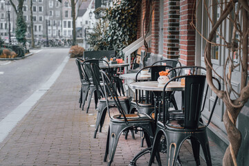 City restaurant. Outdoor table. A small street.