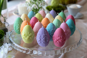 Colorful easter egg soy wax candles. Spring background