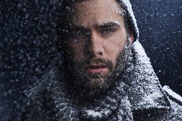 Snow, night and man with serious portrait outdoor in winter with storm, ice and travel with cold...