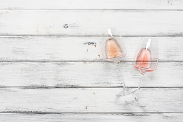 Two glasses with different shade rose wine flat lay on a white wooden background. Top view. - 759750110