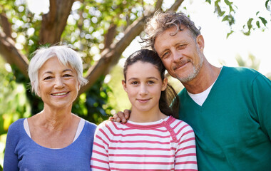 Portrait, grandparents or kid as family, visit or care to relax as happy, bonding or together. Man, woman or child as smile, sunshine or retirement in garden on morning summer day in San Francisco