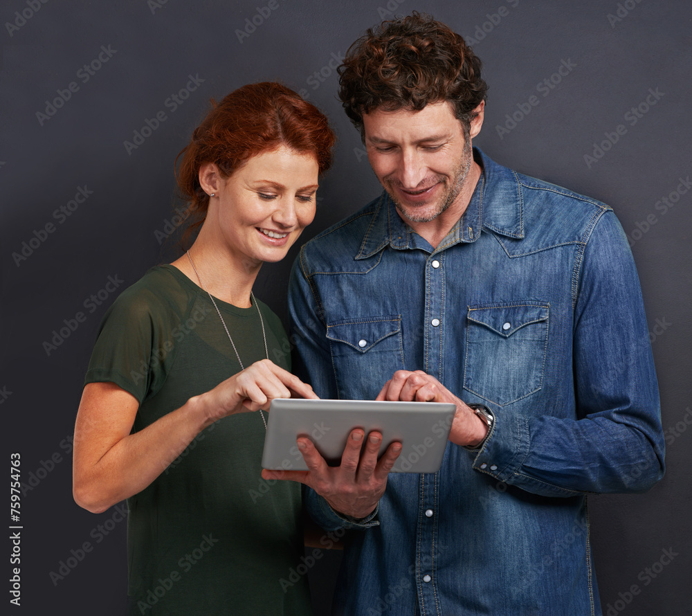 Poster happy couple, typing and communication with tablet for research or networking on a dark studio backg