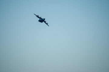 RAF Royal Air Force Airbus A400M Atlas military transport plane banking hard on a cargo parachute drop run over Wiltshire UK