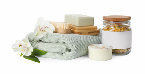 Fototapeta na wymiar Spa composition. Towel, personal care products, brush, fresh and dry flowers on white background