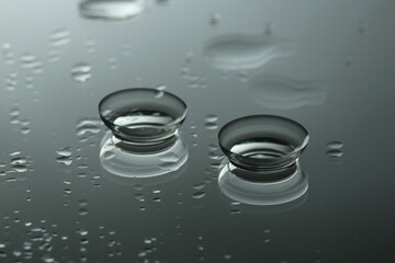 Pair of contact lenses on wet mirror surface